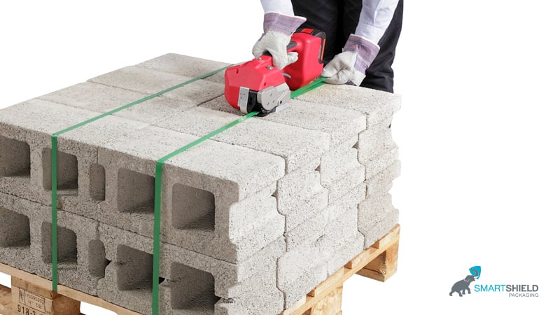 Blocks being strapped to pallets with plastic strapping